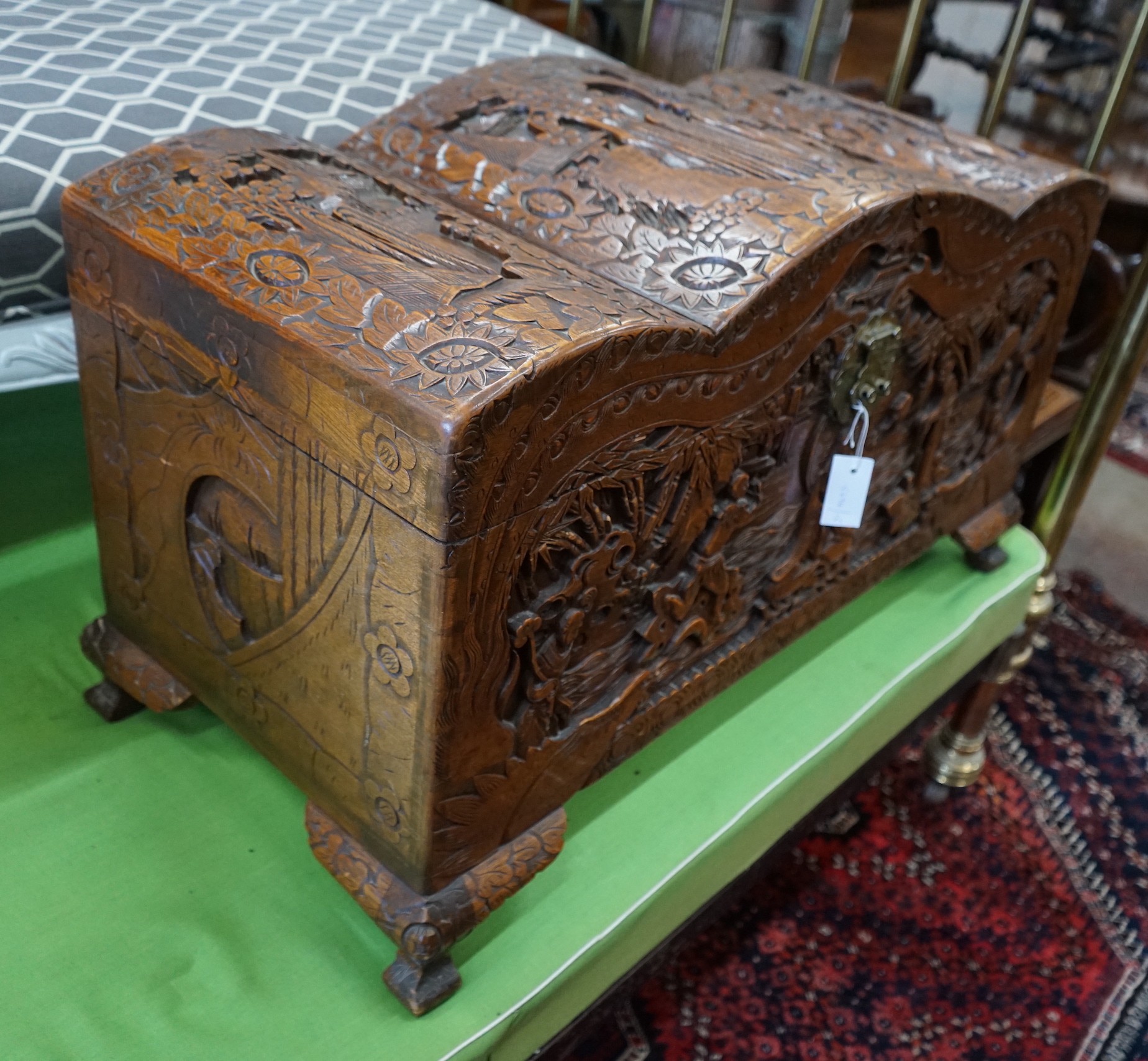 A Chinese carved camphorwood coffer with domed cover, length 93cm, depth 43cm, height 55cm